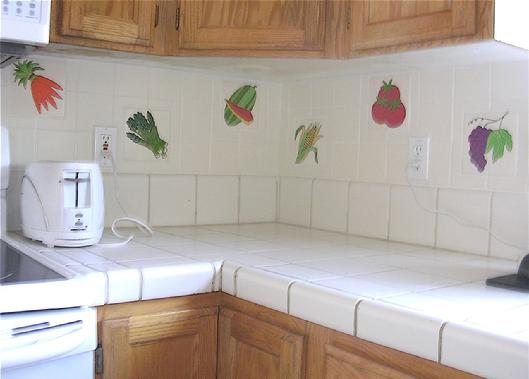 FRUIT TILES and VEGETABLE TILES in 6" x 6" SIZE, ARE SKILLFULLY SET IN A FIELD OF 4" x 4" TILES. A CREATIVE KITCHEN BACKSPLASH INSTALLATION USING BESHEER ART TILE